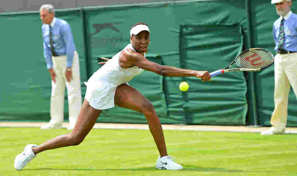 Venus Williams stretches for a return in her first-round defeat to Russia's Elena Vesnina on the first day of the Wimbledon Championships. For Williams, 32, it was her earliest exit from Wimbledon in 15 years.
