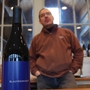 New York Winemaker Christopher Tracy and a bottle of his Blaufrankisch. The wine's difficult to pronounce name may attract oenophiles.