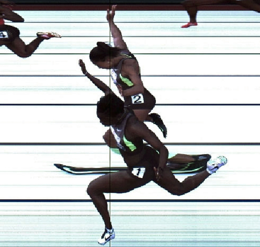 In this handout photo provided by the USATF, Jeneba Tarmoh (bottom, lane 1) and Allyson Felix cross the finish line at exactly the same time in the women's 100 meter dash final during Day Two of the 2012 U.S. Olympic Track & Field Team Trials at Hayward Field on Saturday in Eugene, Ore. It's their torsos, not head, hands, feet or arms, that matter.