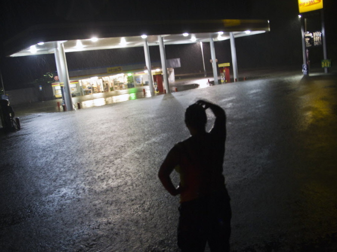 Convenience store employee Lindsey Bennight watched floodwaters surround the store where she works in Crawfordville, Fla., on Monday (June 25, 2012).