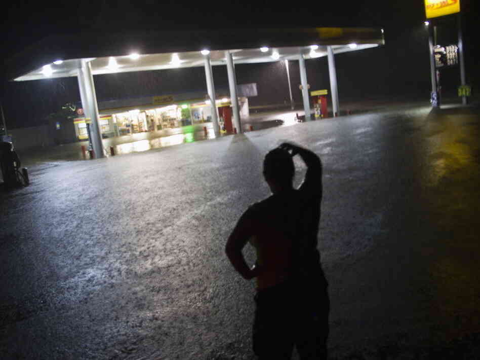 Convenience store employee Lindsey Bennight watched floodwaters surround the store where she works in Crawfordville, Fla., on Monday (June 25, 2012).