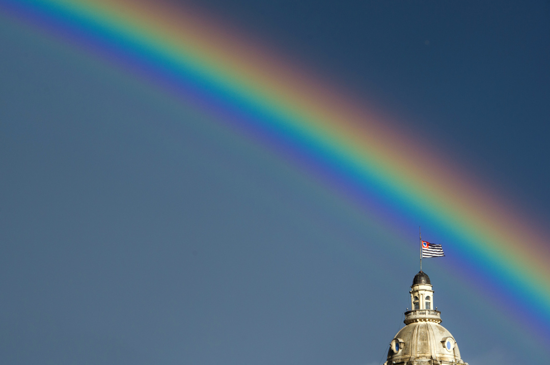 A rainbow over the flag of the Brazilian state of Sao Paulo after the rain on January 14, 2012.