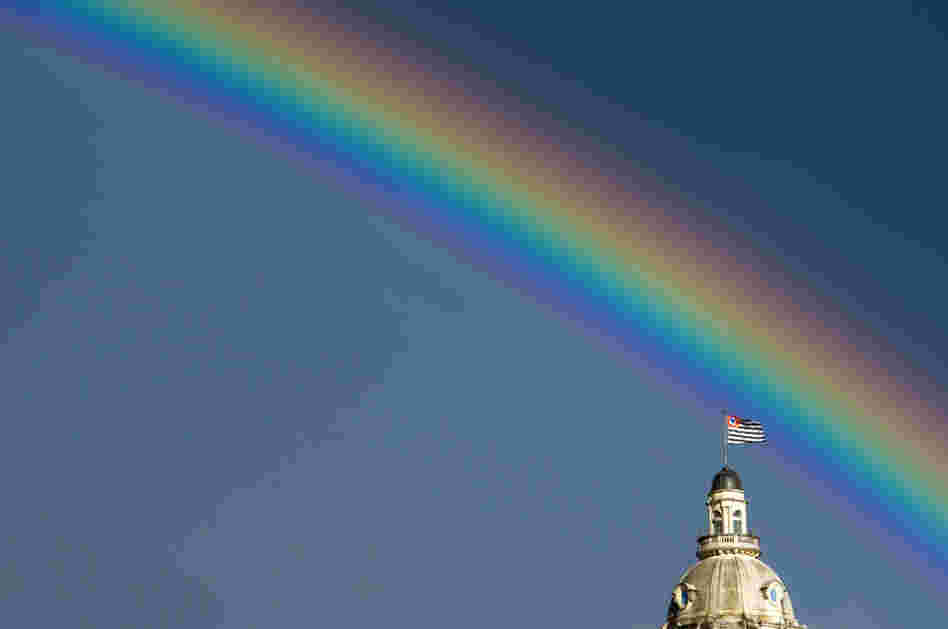 A rainbow over the flag of the Brazilian state of Sao Paulo after the rain on January 14, 2012.