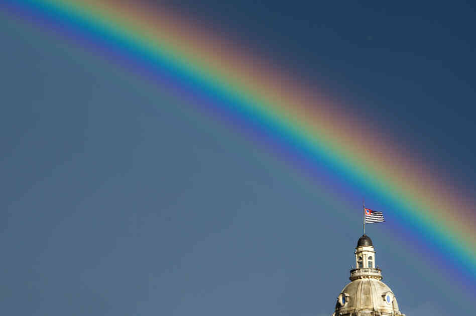 A rainbow over the flag of the Brazilian state of Sao Paulo after the rain on January 14, 2012.