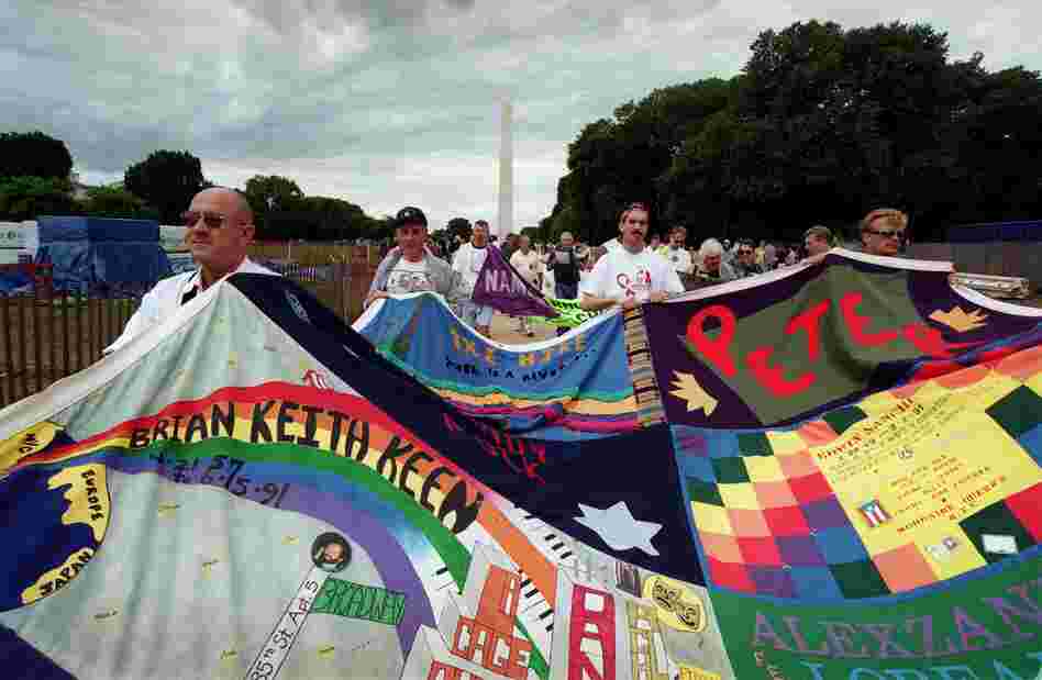 Marchers carry portions of the quilt through the Mall during a 2001 march in observance of the 20th year of public awareness of HIV and AIDS.