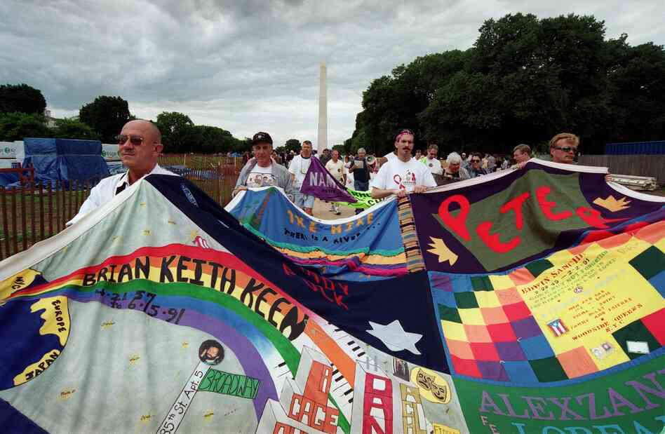 Marchers carry portions of the quilt through the Mall during a 2001 march in observance of the 20th year of public awareness of HIV and AIDS.