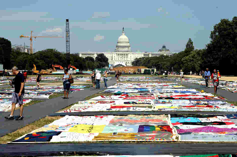 Visitors tour portions of the AIDS Memorial Quilt on display at the National Mall this week. 