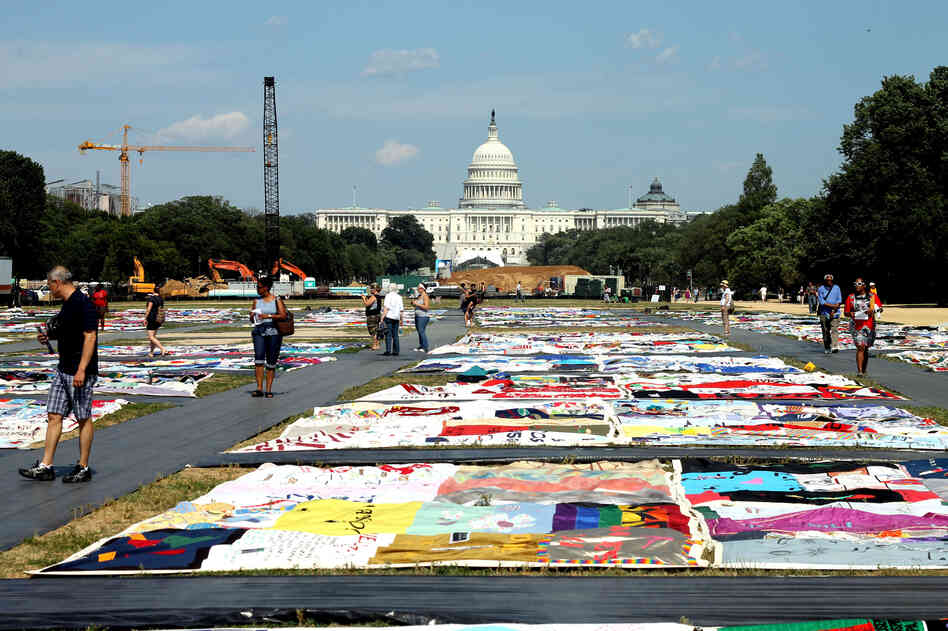 Visitors tour portions of the AIDS Memorial Quilt on display at the National Mall this week. 