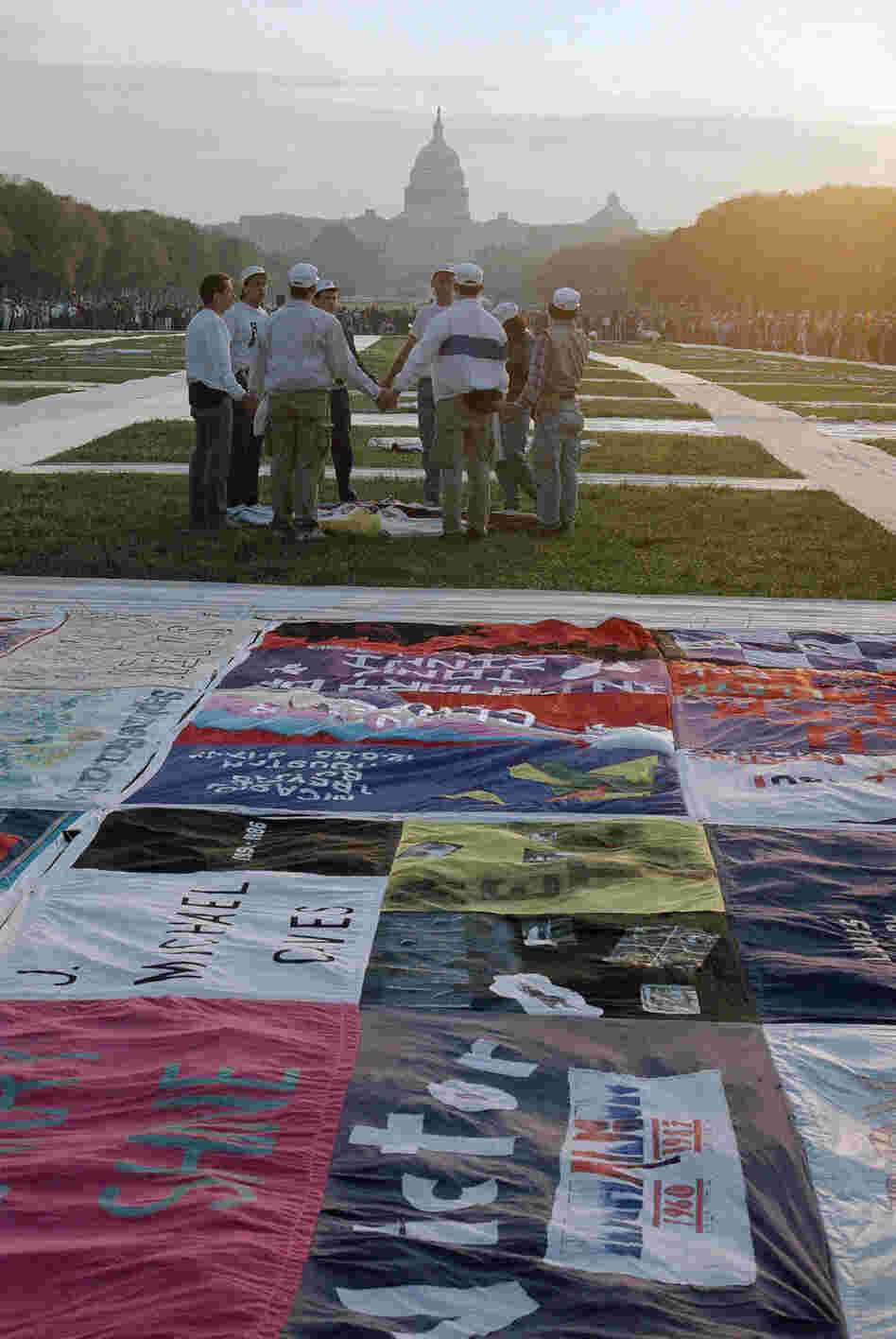 A sunrise ceremony is held in 1987 in Washington, near part of the quilt bearing the names of people who have died of AIDS.