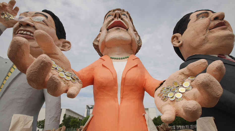 Critics of Germany's spending policy created effigies of Chancellor Angela Merkel (center) and other German leaders to stand near the chancellery in Berlin.