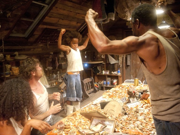Much as playwright Lucy Alibar's father once did, Hushpuppy's father, played by Dwight Henry (right), encourages his daughter (Wallis) to be tough and strong by saying things like, "Show me your guns."