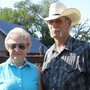 Barbara and Norman Roux stand in front of cattle pens on their farm outside of Moundridge, Kan., where she has raised cattle for nearly 70 years.