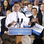 Mitt Romney appears with Virginia Gov. Bob McDonnell (left) on Wednesday. Romney failed to convince Washington Post journalists they were wrong to link him to the outsourcing of U.S. jobs while he led Bain Capital.