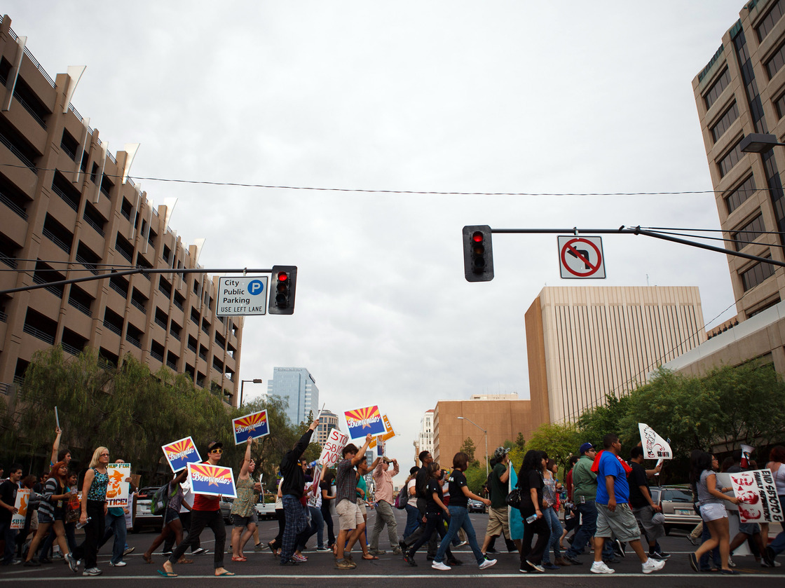 Protesters opposed to Arizona's immigration law march through downtown Phoenix on April 25, the day the U.S. Supreme Court heard arguments over the law.
