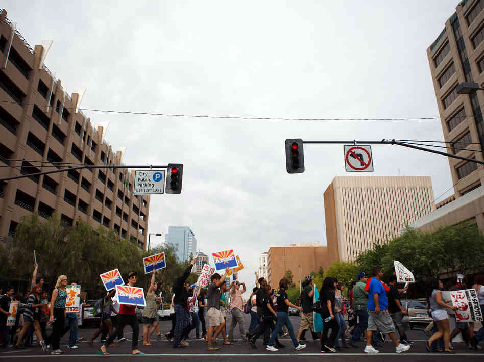 Protesters opposed to Arizona's immigration law march through downtown Phoenix on April 25, the day the U.S. Supreme Court heard arguments over the law.