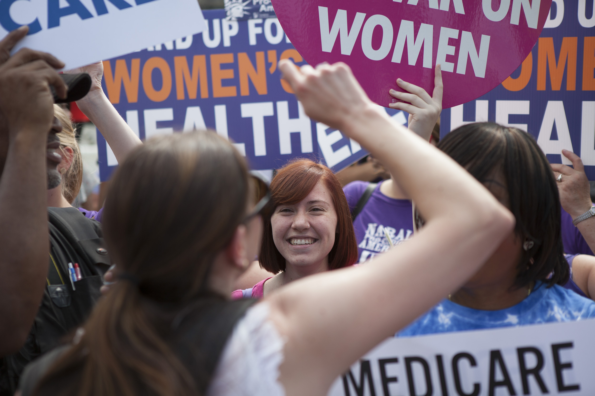 Supporters of President Obama's Affordable Care Act celebrate outside the Supreme Court. Across from the celebration, protesters voiced their opposition to the court's ruling. (Image credit: NPR)
