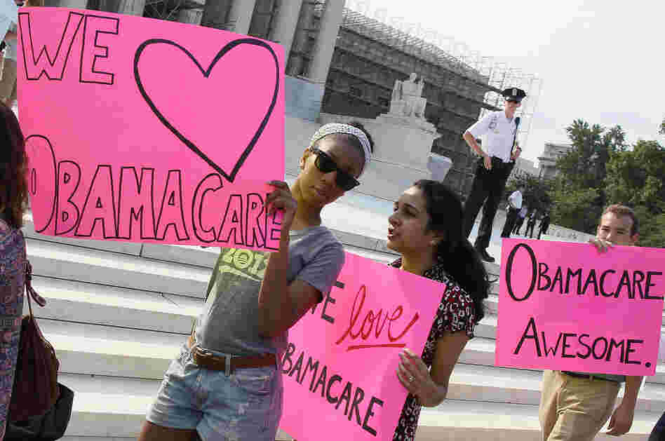 Supporters of the health care law march in front of the Supreme Court building.