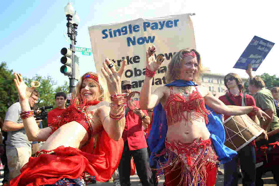 Two supporters of the law belly-dance as they demonstrate in front of the Supreme Court.
