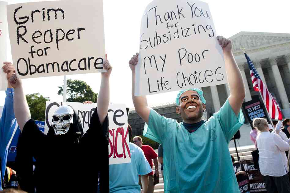 Opponents of the law, dressed as President Obama and the Grim Reaper, await a decision by the Supreme Court.