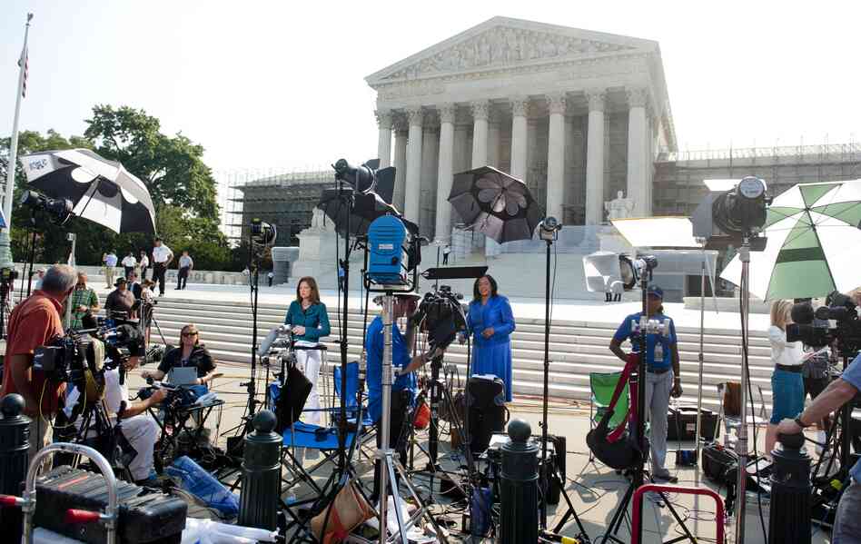 Reporters await a decision by the Supreme Court on the constitutionality of the Affordable Healthcare Act, President Barack Obama's signature healthcare legislation.