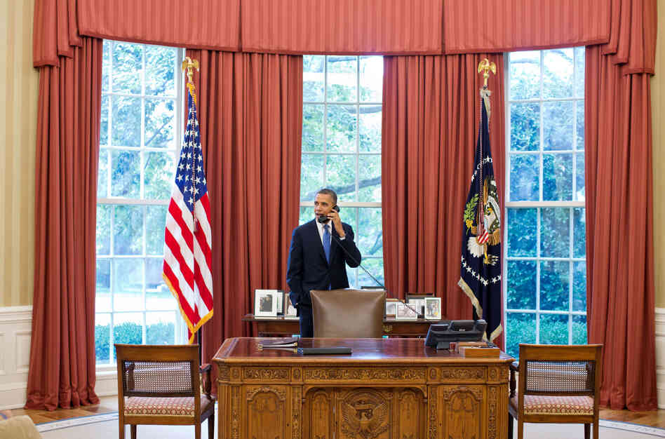 President Barack Obama talks on the phone with Solicitor General Donald Verrilli in the Oval Office, after learning of the Supreme Court's ruling on the "Patient Protection and Affordable Care Act," on Thursday.
