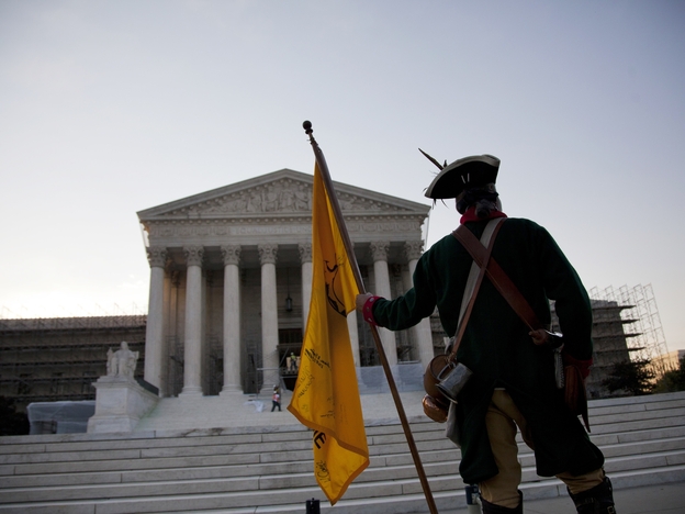William Temple of Brunswick, Ga., waits for the Supreme Court's decision early Thursday. The landmark health care decision that came later ended just one chapter in the nation's long partisan war.