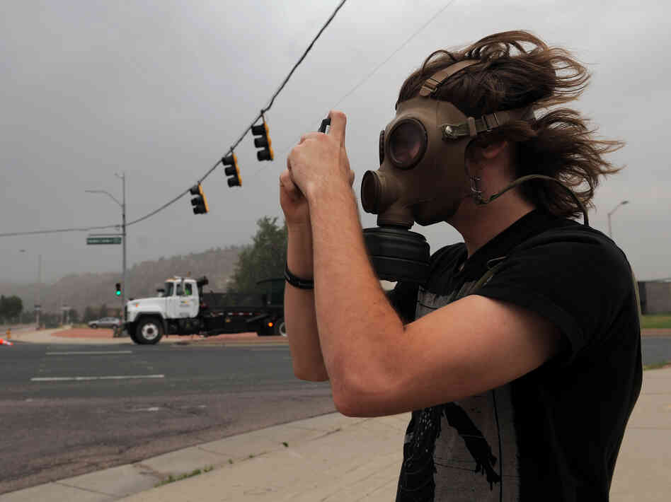 Mikke Carlson took photos of the smoke from the Waldo Canyon fire while wearing a gas mask on Wednesday in Colorado Springs, Colo.