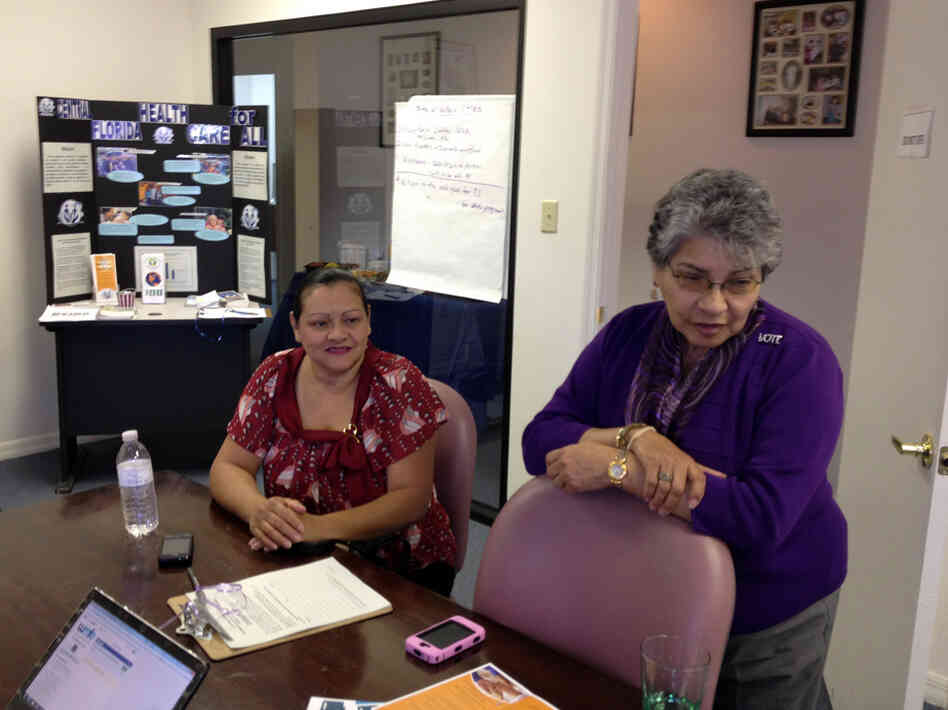 Josephine Mercado (right) with Brenda Serrano at the Hispanic Health Initiatives office in Casselberry, Fla. Mercado says she plans a party now that the Supreme Court has ruled on the health law.