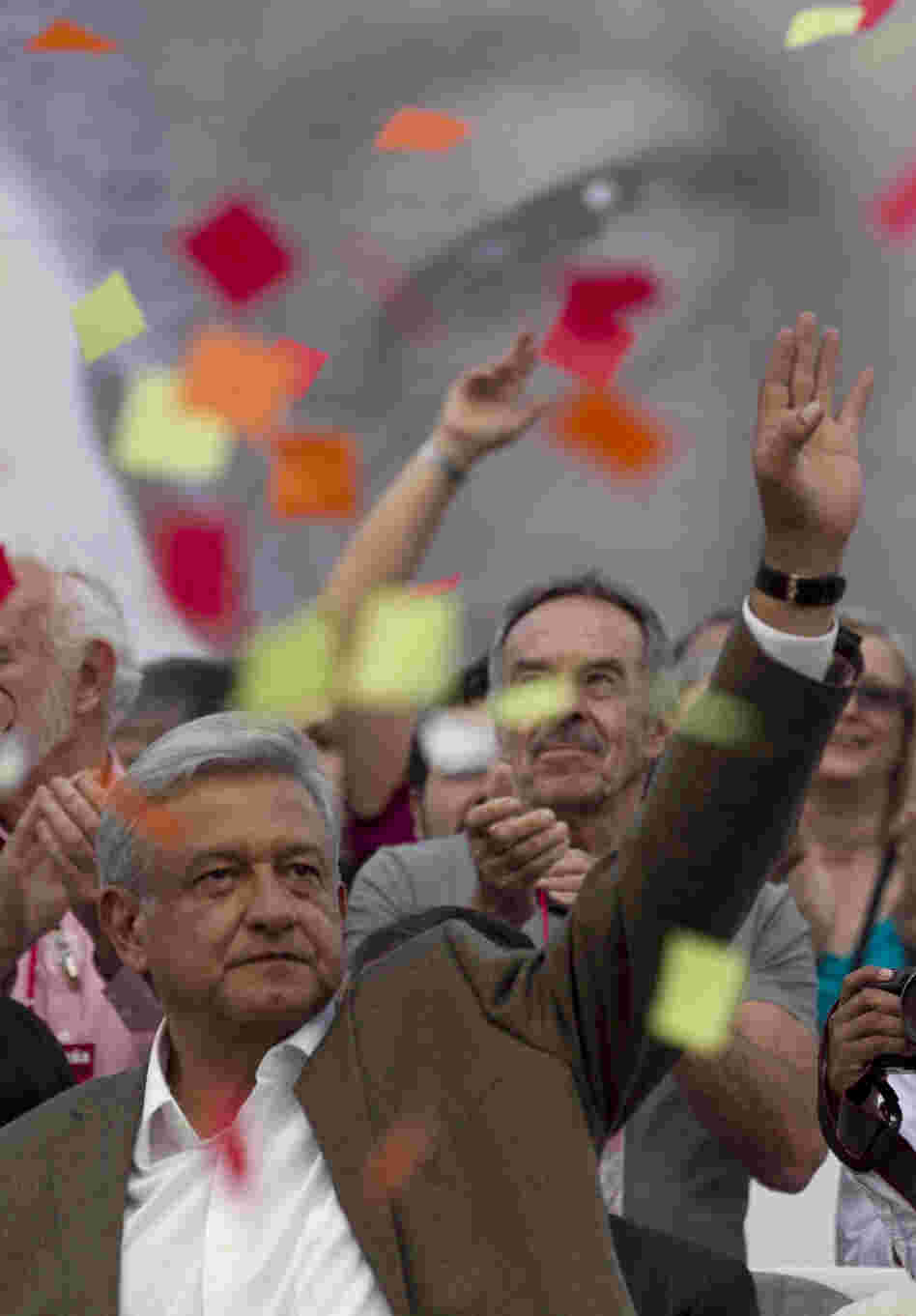 Andres Manuel Lopez Obrador, presidential candidate for the Democratic Revolution Party, waves at supporters during the closing rally of his campaign at the main Zocalo plaza in Mexico City on Wednesday.