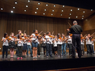 Nathan Schram (back row, third from left) performs with his students from PS 75 in Brooklyn. Nathan Schram (back row, third from left) performs with his students from PS 75 in Brooklyn.
