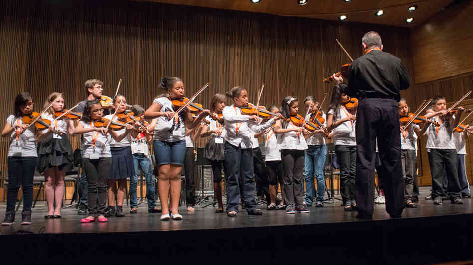 Nathan Schram (back row, third from left) performs with his students from PS 75 in Brooklyn.
