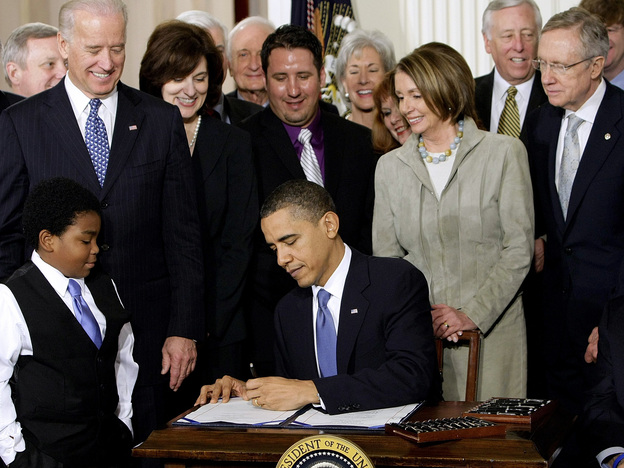 President Obama signs the health care bill into law at the White House on March 23, 2010. (AP)