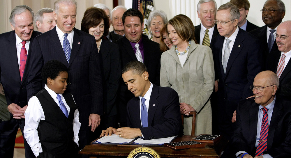 President Obama signs the health care bill into law at the White House on March 23, 2010.