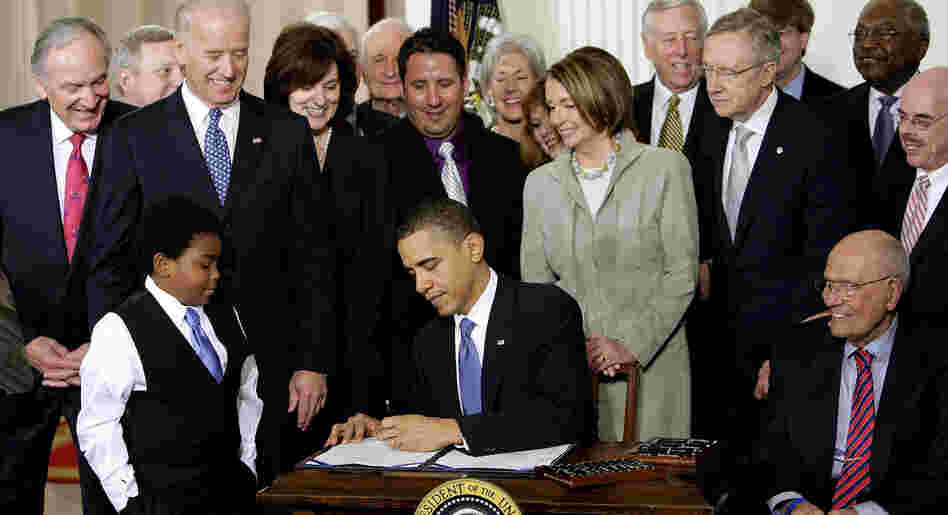 President Obama signs the health care bill into law at the White House on March 23, 2010.