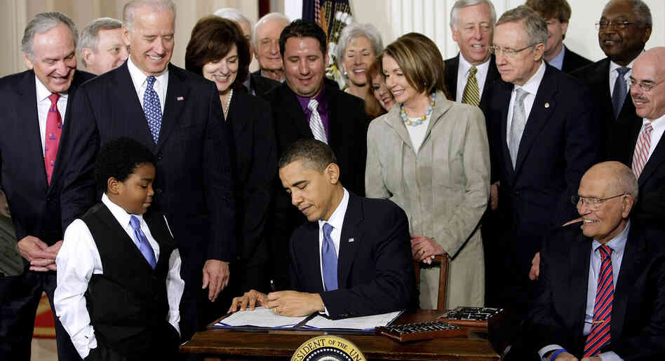 President Obama signs the health care bill into law at the White House on March 23, 2010.