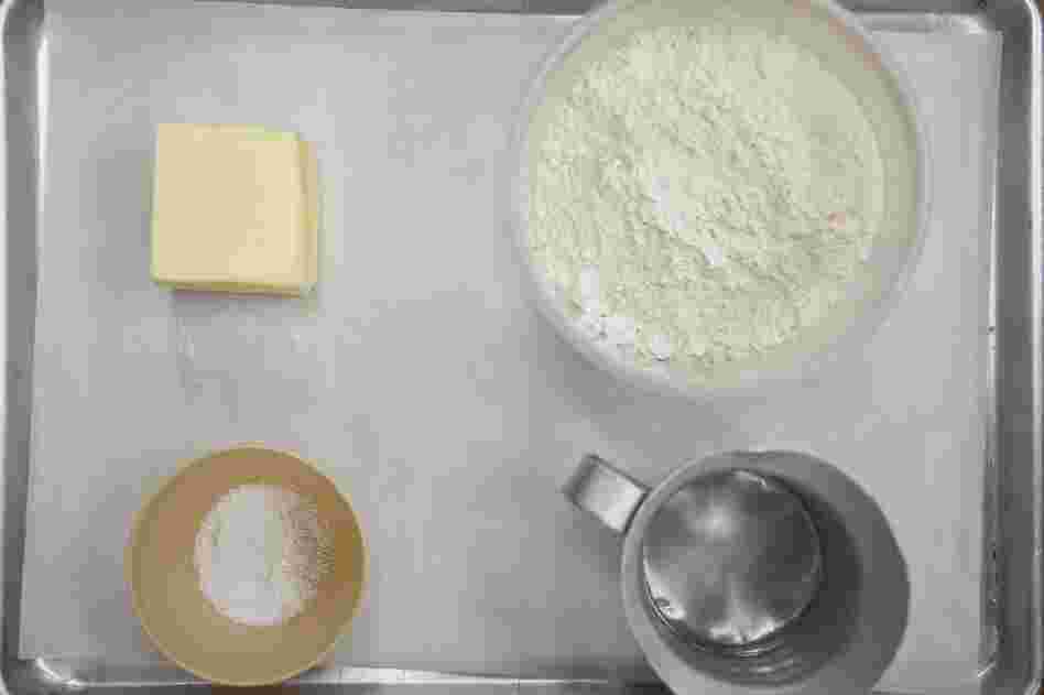 To make a flaky pie crust, start by measuring out 12 oz. (by weight) flour, 8 oz. firm butter, 4 oz. ice water. Keeping it cool is key.
