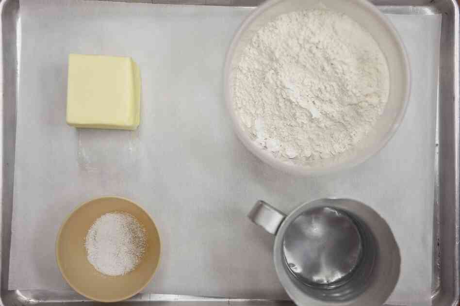 To make a flaky pie crust, start by measuring out 12 oz. (by weight) flour, 8 oz. firm butter, 4 oz. ice water. Keeping it cool is key.