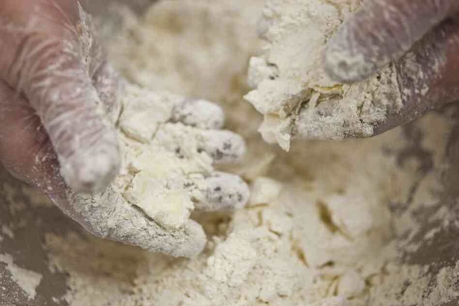 Flake the butter chunks into the flour. The chunks should still be visible.