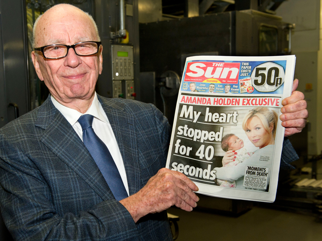 Rupert Murdoch, chairman and CEO of News Corp., with one of his company's British tabloids.