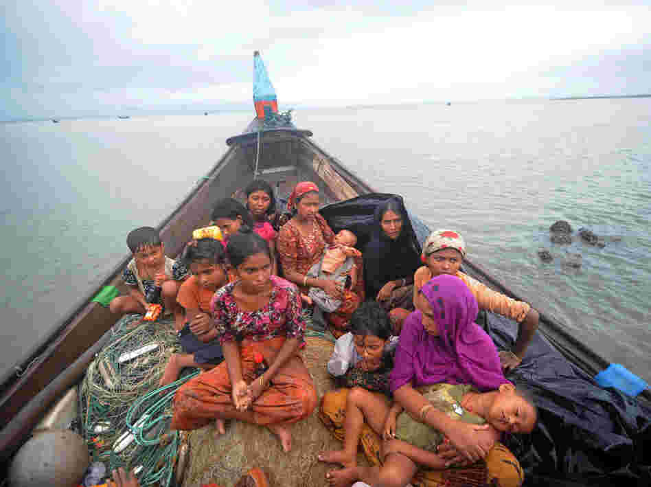 Rohingya Muslims, trying to cross the Naf river into Bangladesh to escape sectarian violence in Myanmar, look on from an intercepted boat in Teknaf, June 13. The plight of the Rohingya minority is one of the tests Suu Kyi faces at home.