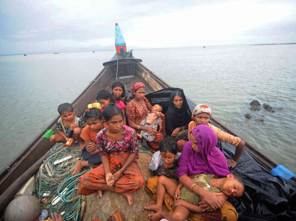 Rohingya Muslims, trying to cross the Naf river into Bangladesh to escape sectarian violence in Myanmar, look on from an intercepted boat in Teknaf, June 13. The plight of the Rohingya minority is one of the tests Suu Kyi faces at home.