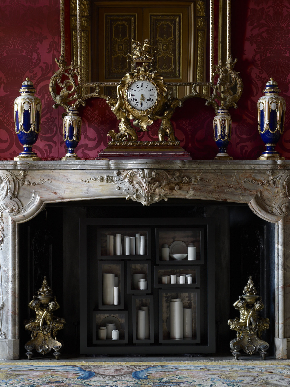 In the Red Drawing Room, de Waal has placed 48 thrown porcelain vessels, jars and dishes in the hearth for his work the properties of fire.