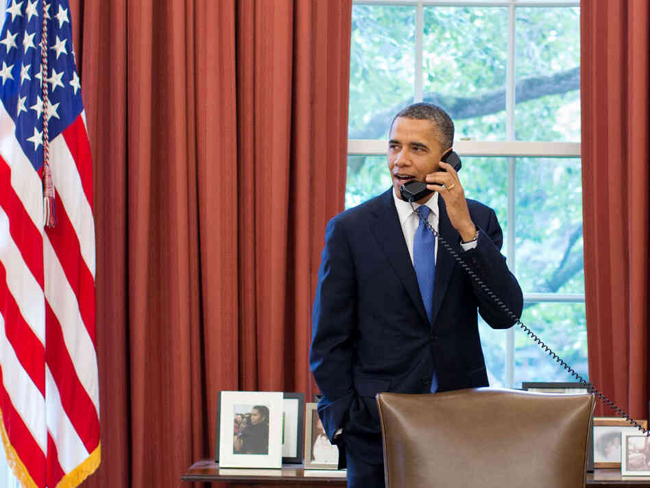 President Barack Obama talks on the phone with Solicitor General Donald Verrilli in the Oval Office, after learning of the Supreme Court's ruling on the "Patient Protection and Affordable Care Act," on Thursday.
