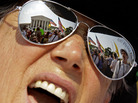 The Supreme Court is reflected in the sunglasses of Susan Clark on Thursday as she demonstrates against President Obama's health care law. The Supreme Court is reflected in the sunglasses of Susan Clark on Thursday as she demonstrates against President Obama's health care law.