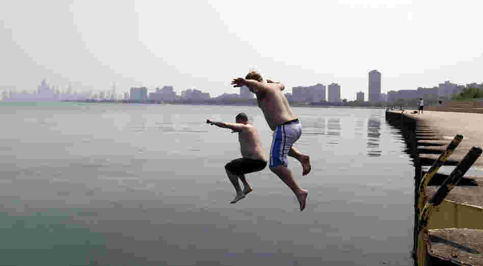 Jason Gerald (left) and Adam Hoffman jump into the Lake Michigan at Montrose Beach in Chicago on Thursday. 