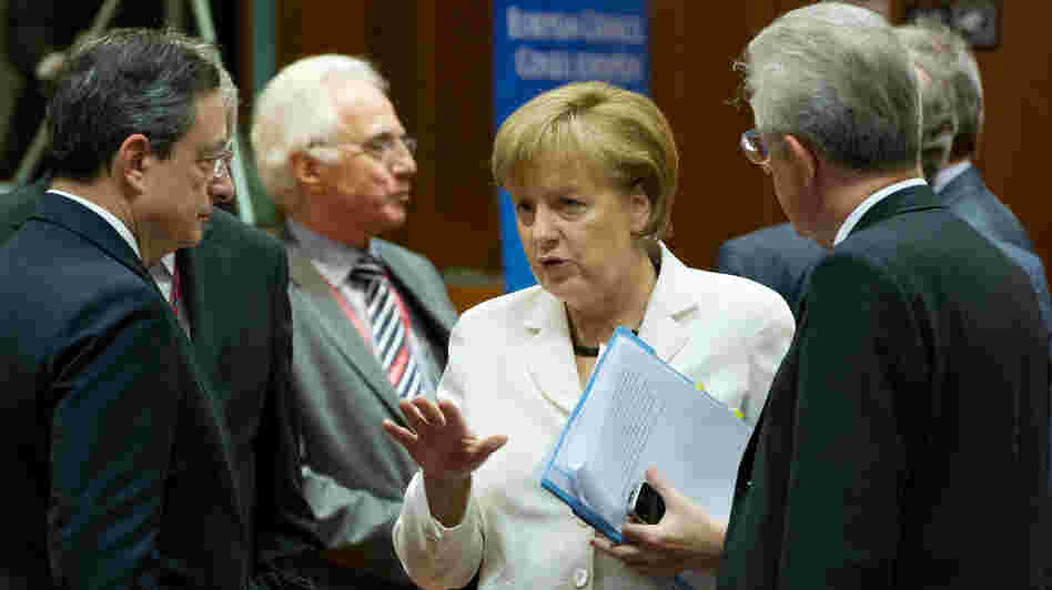 German Chancellor Angela Merkel talks with European Central Bank President Mario Draghi (left) and Italian Prime Minister Mario Monti (right) during a summit of European leaders in Brussels. They reached an agreement on a growth plan for the continent, and world markets surged. German Chancellor Angela Merkel talks with European Central Bank President Mario Draghi (left) and Italian Prime Minister Mario Monti (right) during a summit of European leaders in Brussels. They reached an agreement on a growth plan for the continent, and world markets surged.