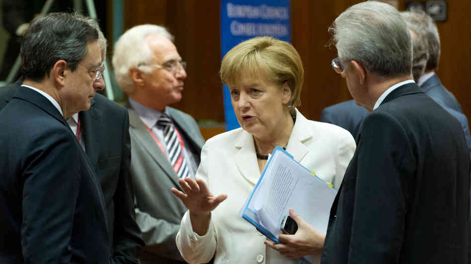 German Chancellor Angela Merkel talks with European Central Bank President Mario Draghi (left) and Italian Prime Minister Mario Monti (right) during a summit of European leaders in Brussels. They reached an agreement on a growth plan for the continent, and world markets surged. German Chancellor Angela Merkel talks with European Central Bank President Mario Draghi (left) and Italian Prime Minister Mario Monti (right) during a summit of European leaders in Brussels. They reached an agreement on a growth plan for the continent, and world markets surged.