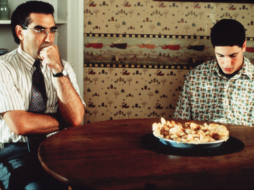 Eugene Levy with Jason Biggs and the now-infamous defaced pie in one of his most popular recurring roles as Jim's dad in American Pie.