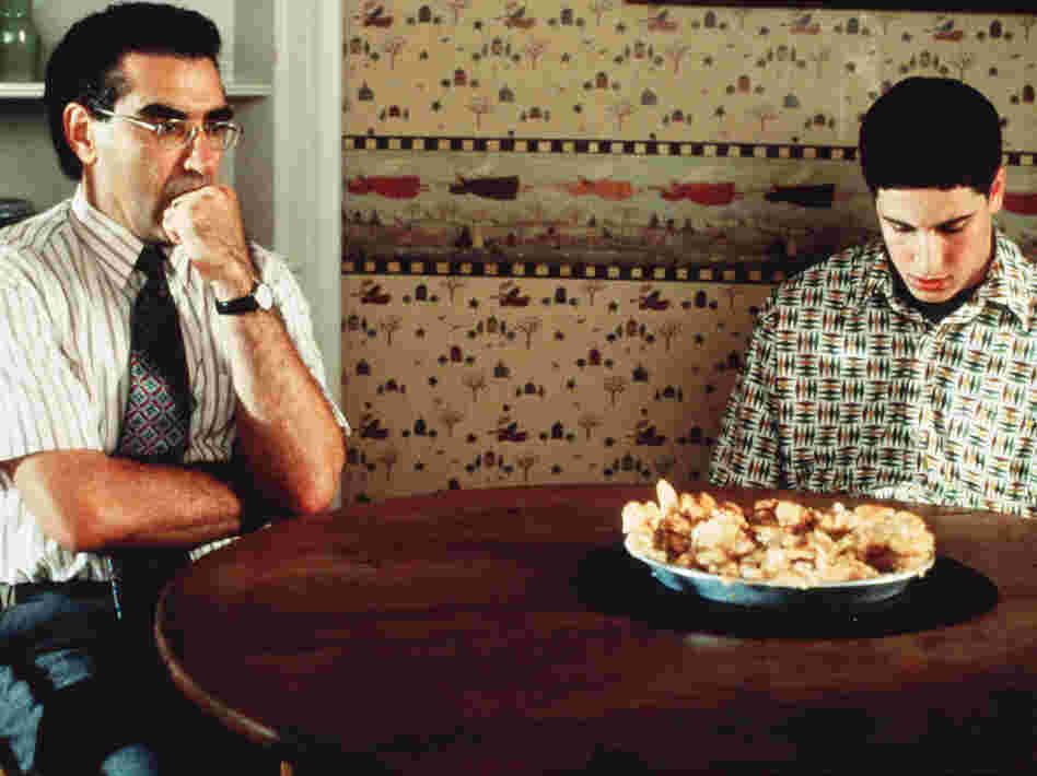 Eugene Levy with Jason Biggs and the now-infamous defaced pie in one of his most popular recurring roles as Jim's dad in American Pie.