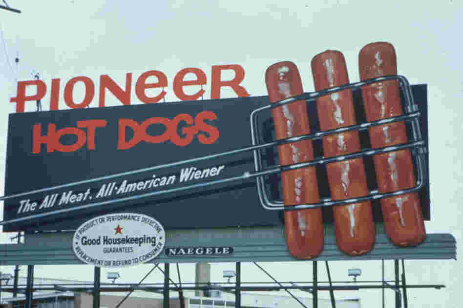 These Pioneer hot dogs look like they are going to jump off of this 1965 billboard and into your mouth.